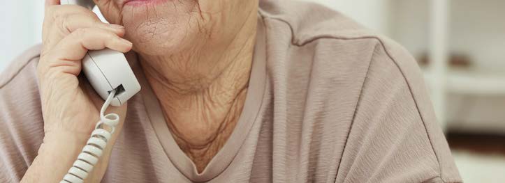 Elderly woman talking on a corded phone